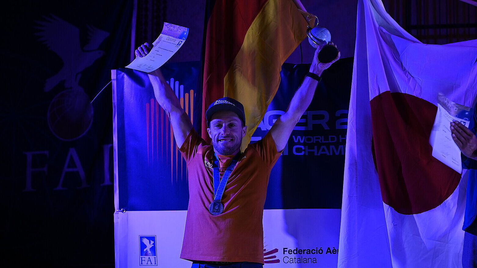 Triumphierender Pilot mit Pokal, Urkunde und Medaille um den Hals